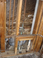 The innards of a plumbing wall